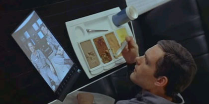 Astronaut Frank Poole watches a news broadcast on a tablet in '2001: A Space Odyssey.'